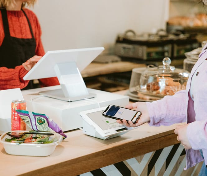 Merchant service concept: Women pay in shop using Clover